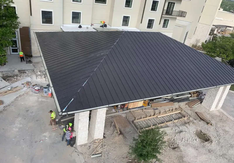 Metal roofing installation team working on a commercial building in Menlo Park